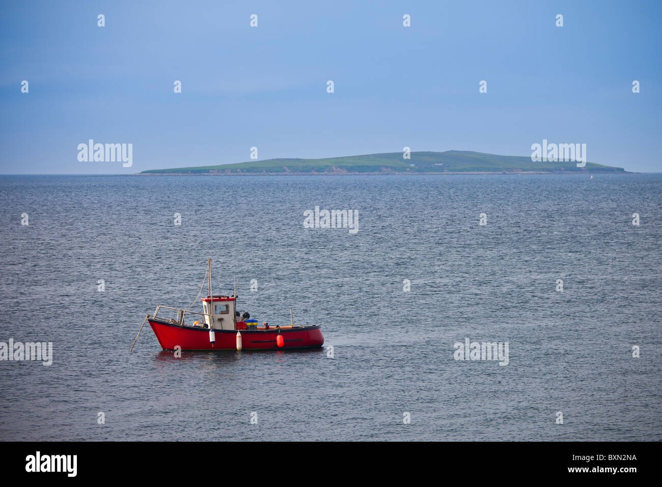 Fishing boat with Saltee Islands in background, Irish Sea at Kilmore, County Wexford, Ireland Stock Photo