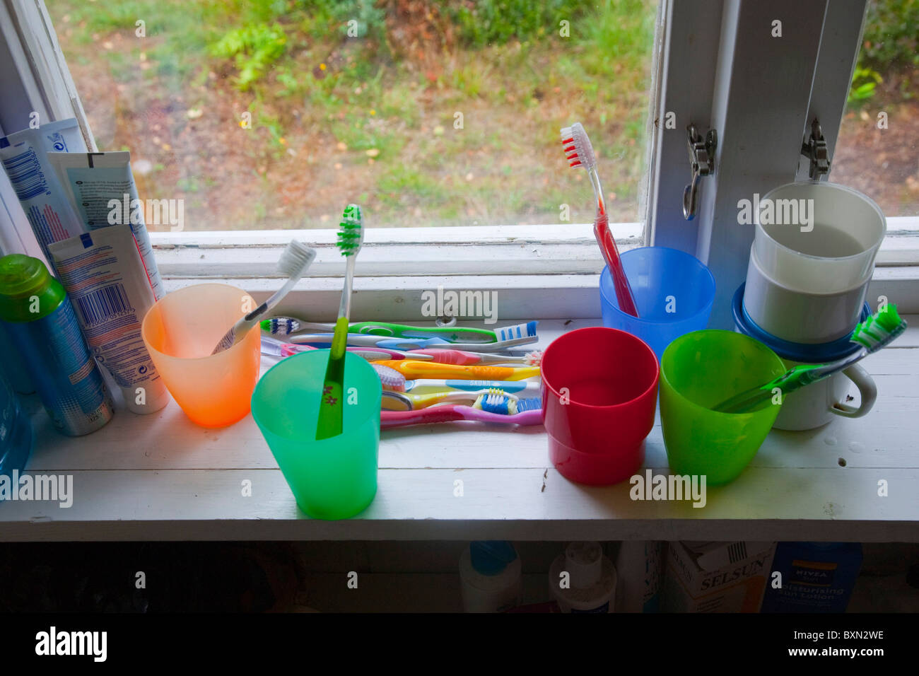 Toothbrushes on a windowsill of a summer house. Stock Photo