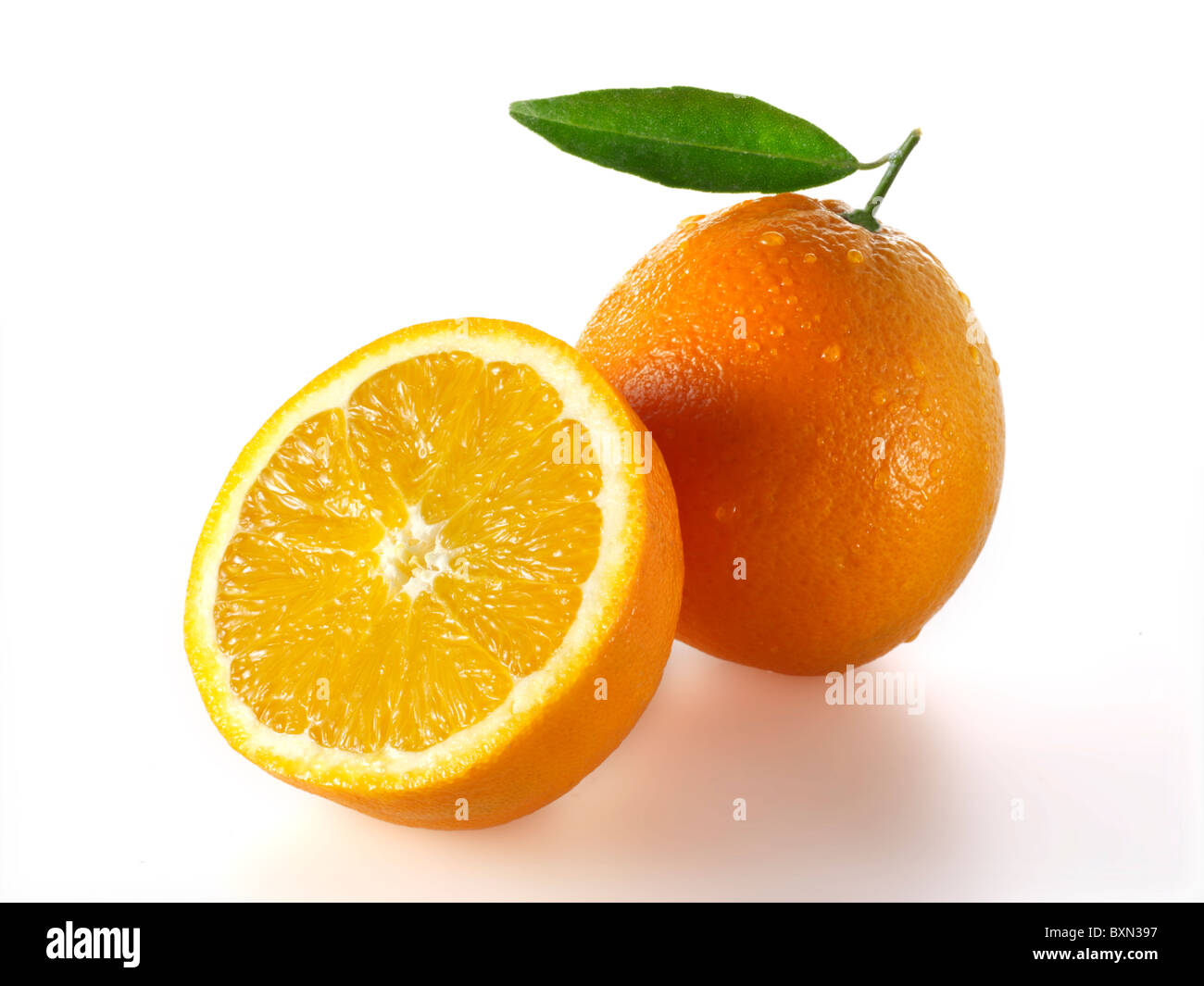 Fresh whole and cut oranges  Stock Photo