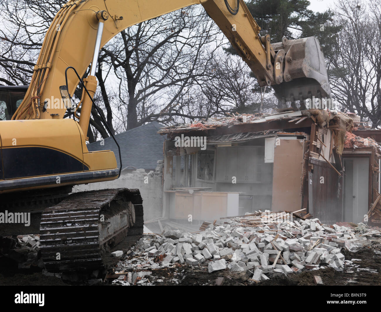 Excavator demolishing a house. Toronto, Canada. Stock Photo