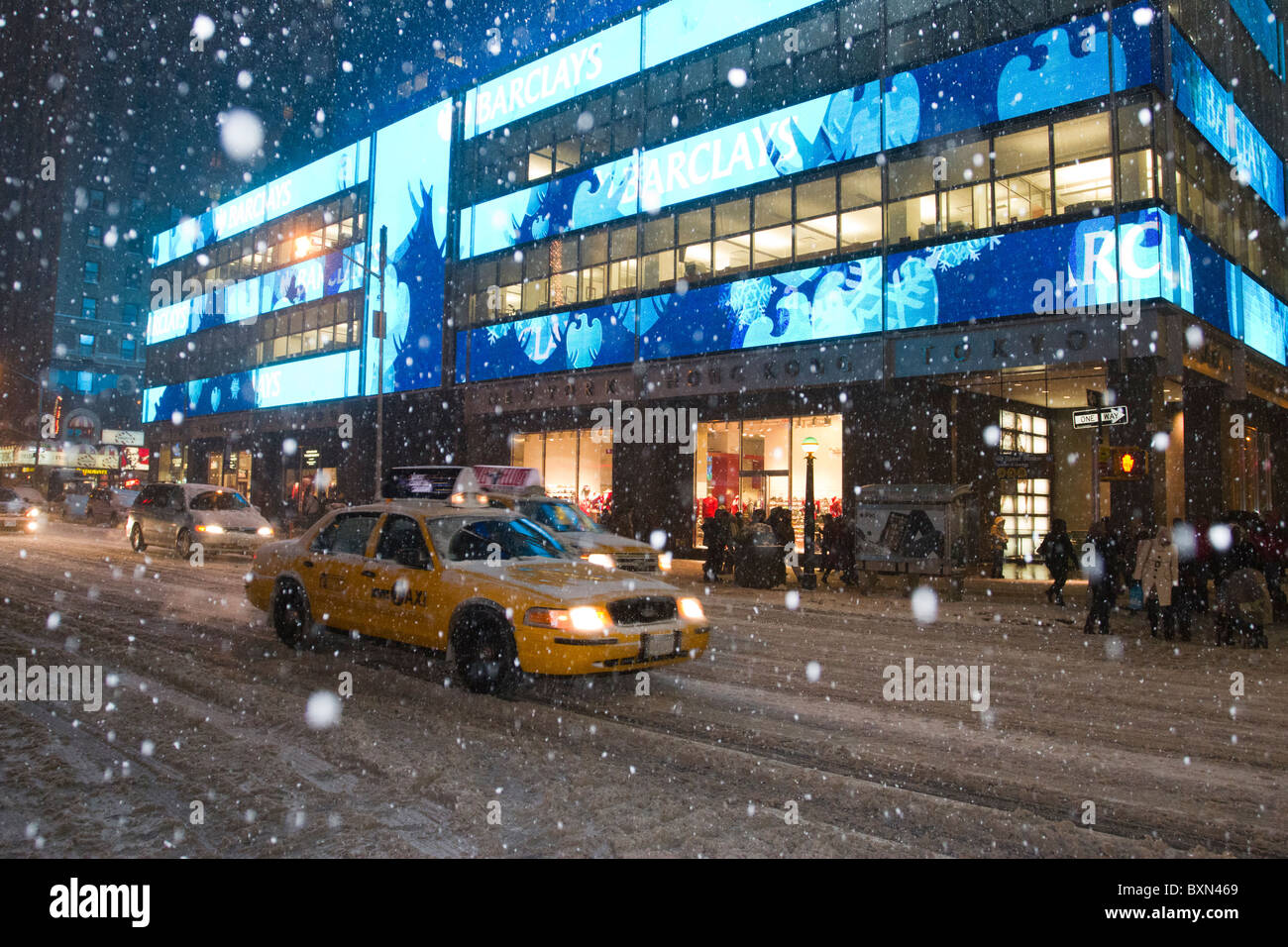 Taxis inch down Seventh Avenue towards Times Square as a blizzard dumps more than two feet of snow on New York City Stock Photo