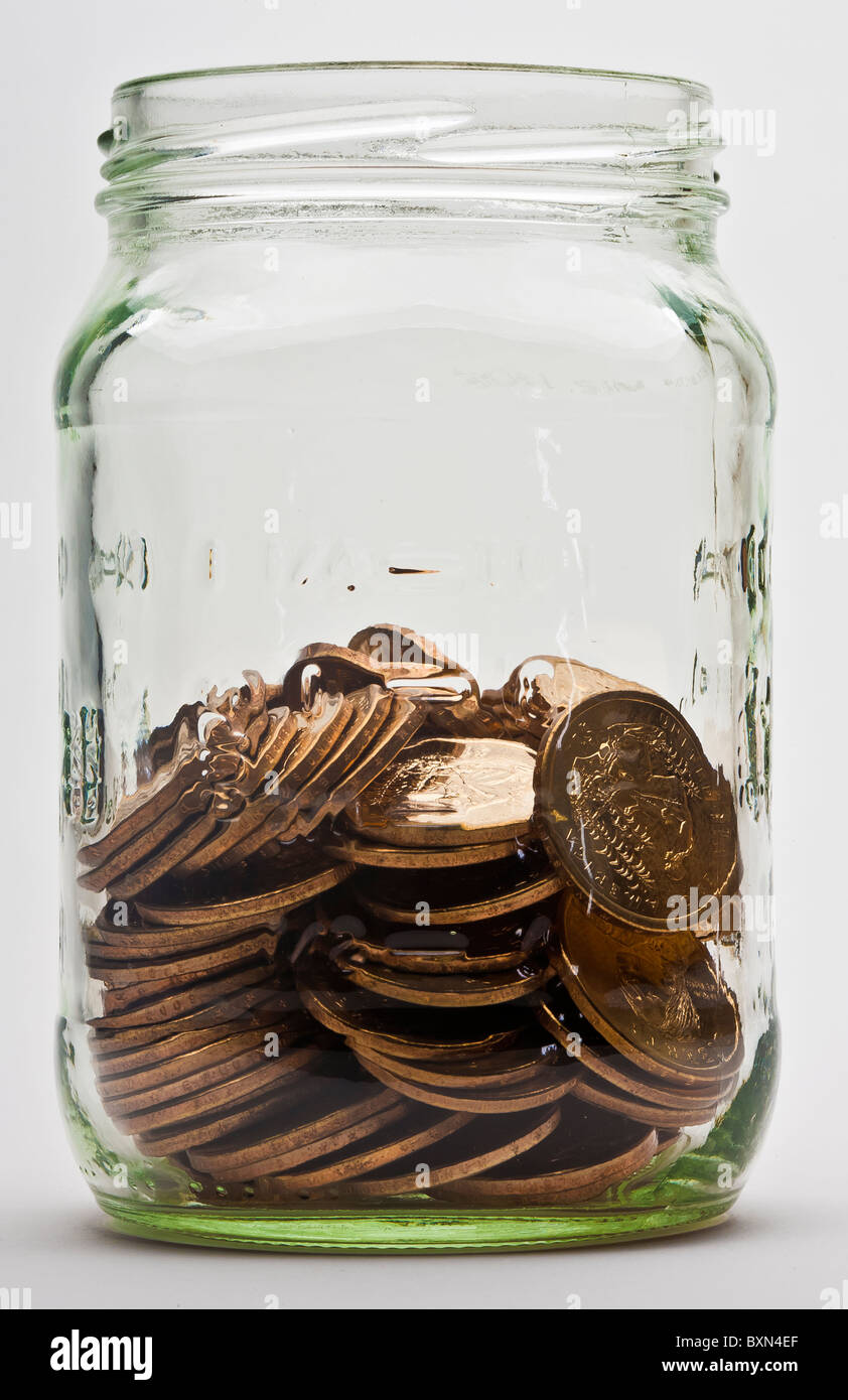one-half full jar of US dollar gold coins Stock Photo
