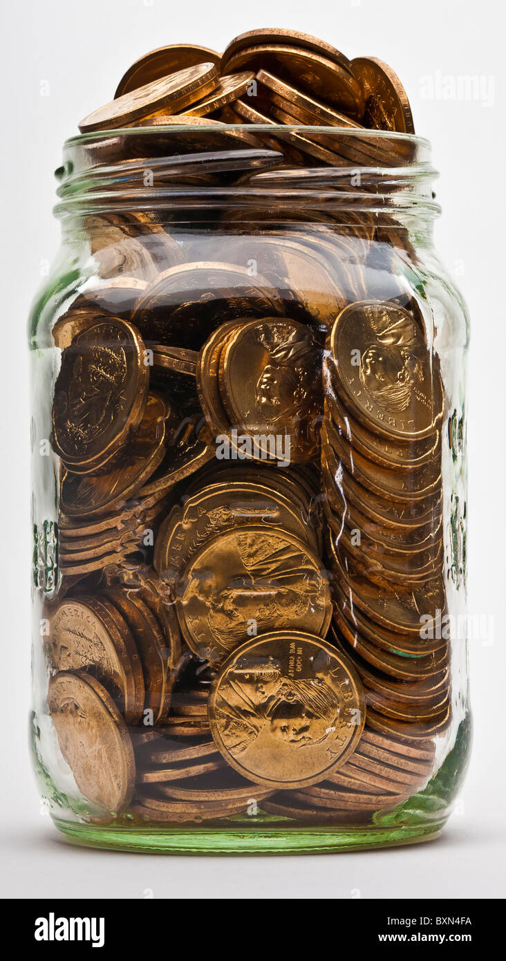 full jar of US dollar gold coins Stock Photo