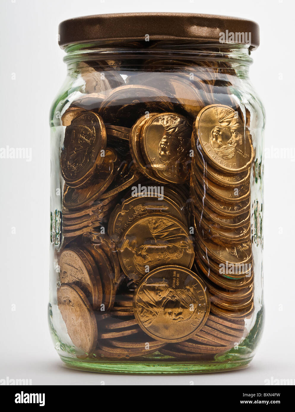 jar full of dollar gold coins Stock Photo