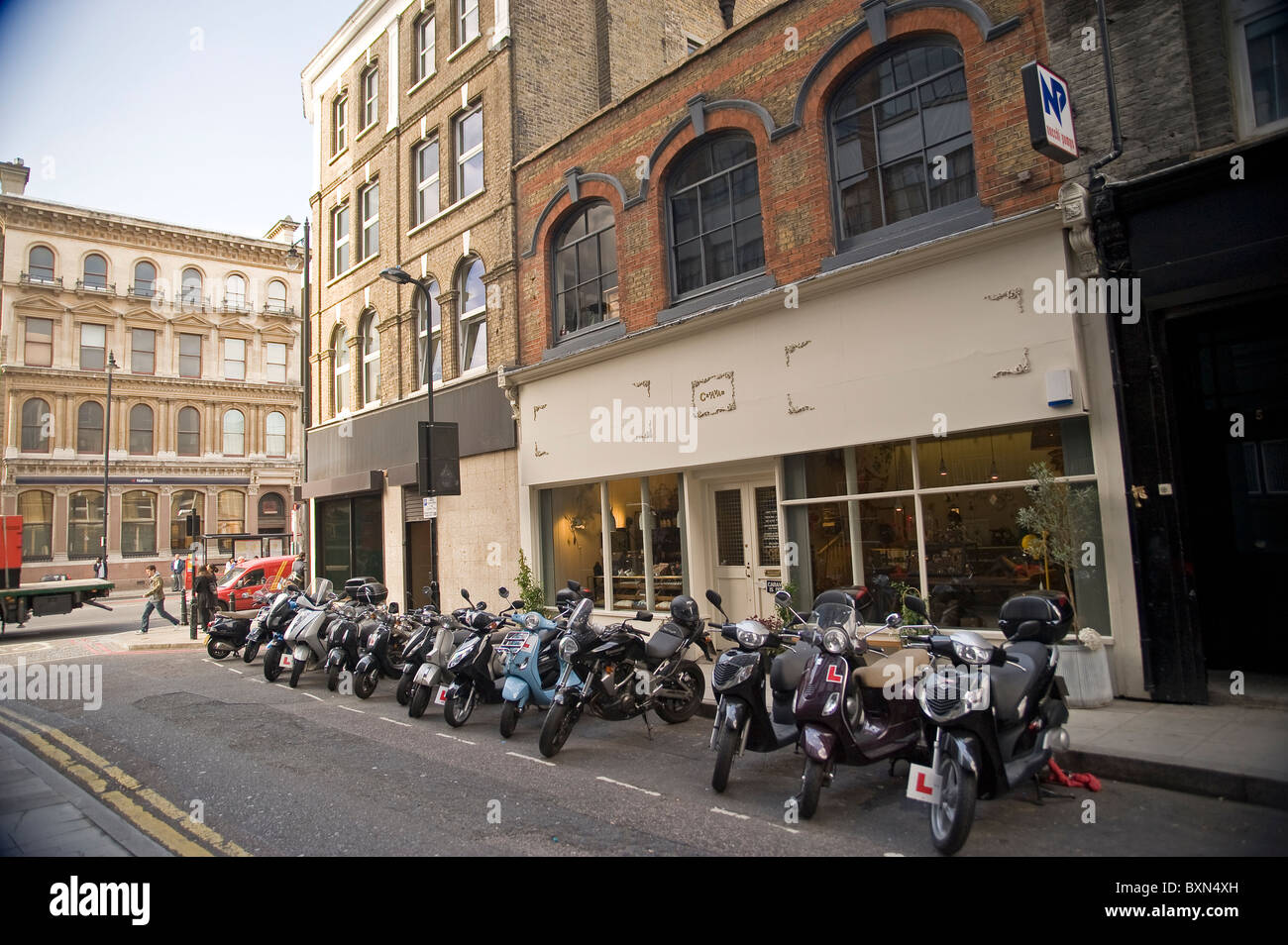 Motorcycles and scooters parked outside 'Caravan' in Redchurch Street, Shoreditch, London, UK