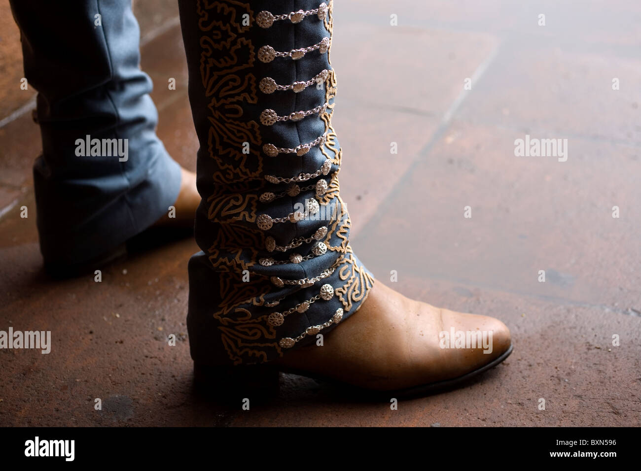 A charro wears silver decorated pants and boots during a charreria competition in Mexico City Stock Photo