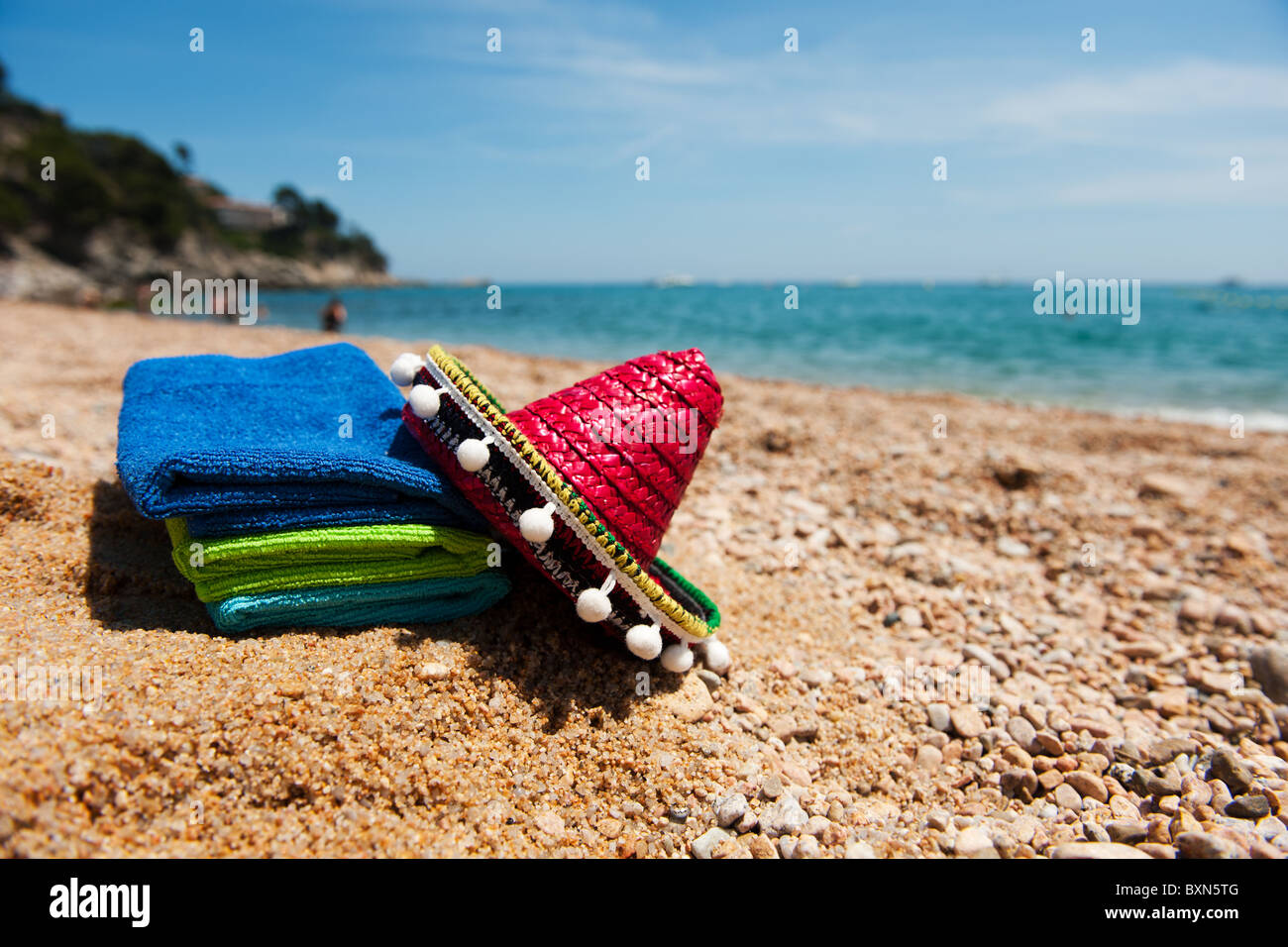 Spanish beach with typical hat and towels Stock Photo Alamy