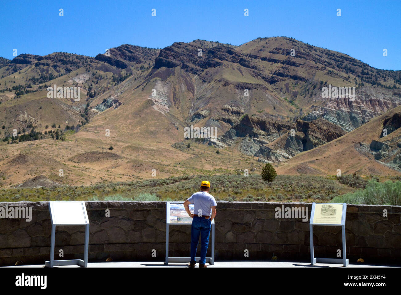 Tourist at the Condon Visitor Center overlooking Sheep Rock at the John