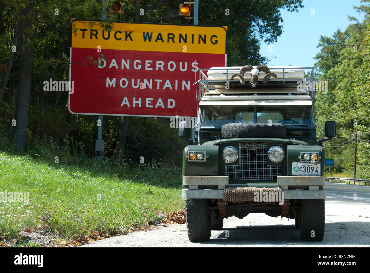 Land Rover Series IIa 109 by danger sign Stock Photo