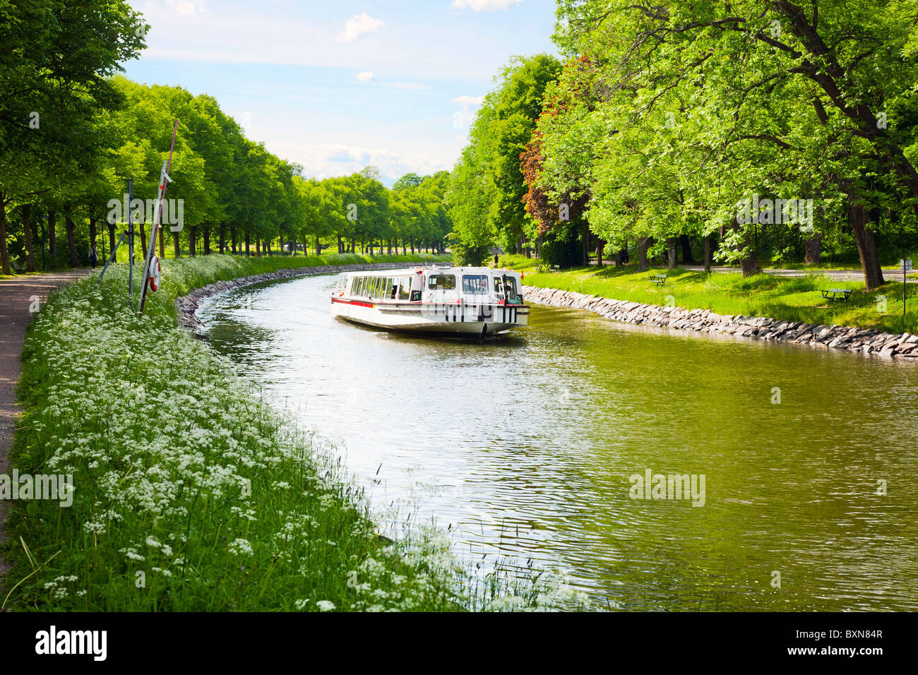 Sightseeing boat on the canal through Djurgarden, Stockholm, Sweden. Stock Photo