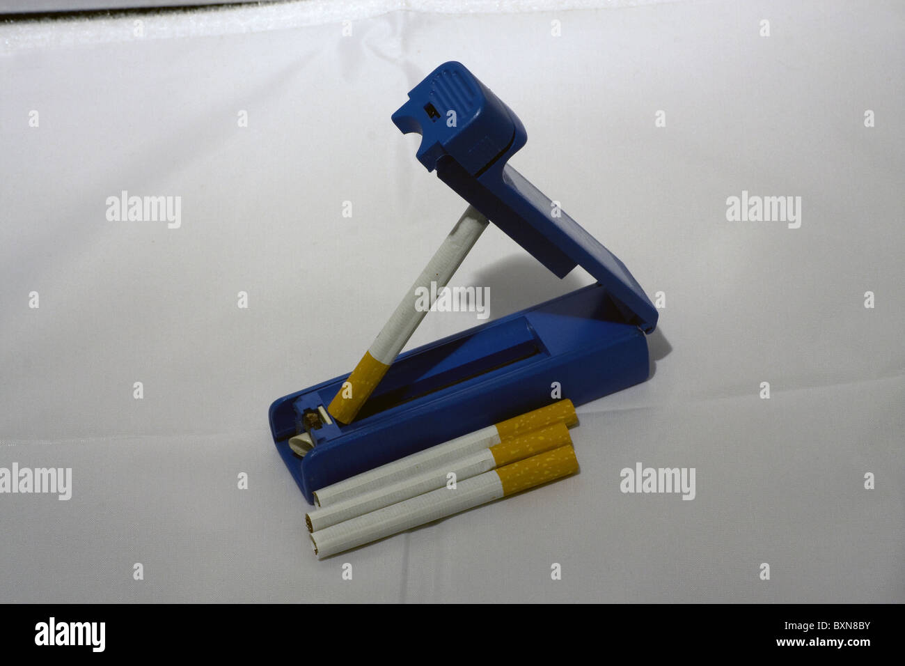 blue cigarette rolling machine filter tip tipped Stock Photo Alamy