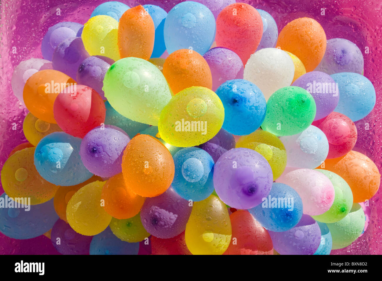 Multicolored moistened water filled balloons viewed from above Stock Photo