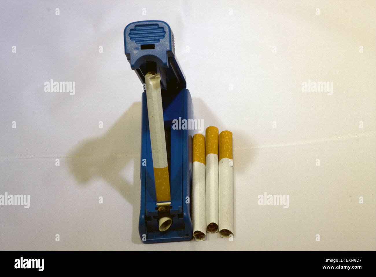 blue cigarette rolling machine filter tip tipped Stock Photo
