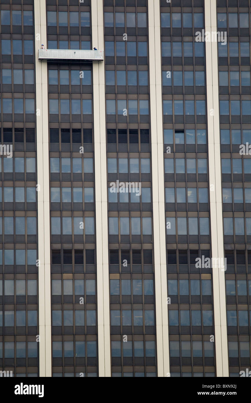 Two window washers wash skyscraper building's windows, New York City