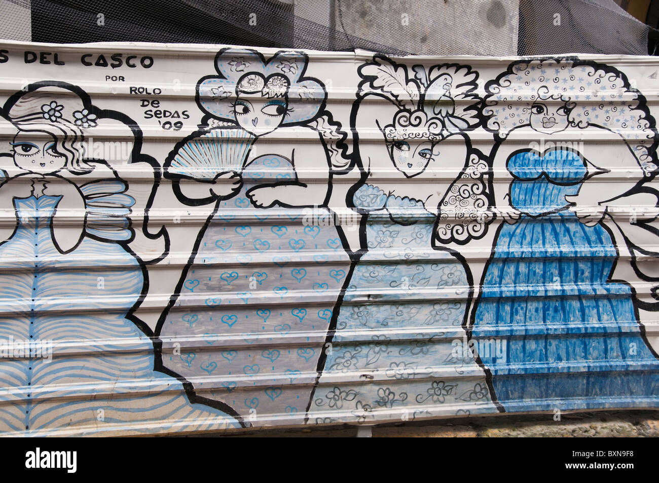 A colorful graffiti painted metal fence provides a safety barrier