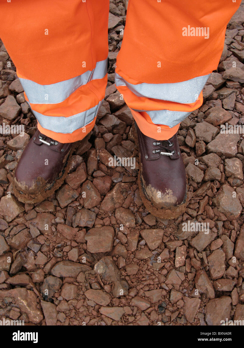 Construction worker wearing safety gear on UK building site Stock Photo