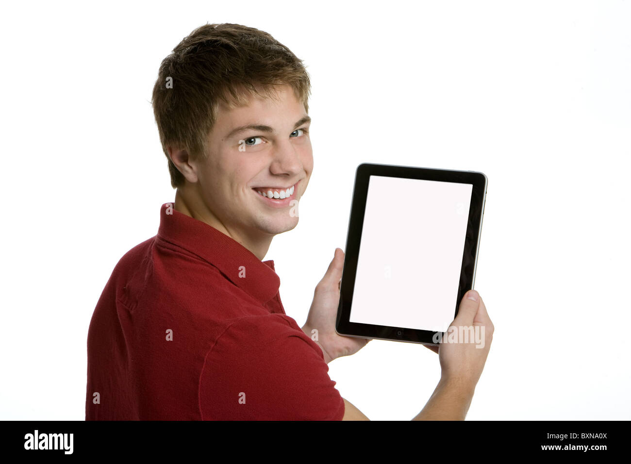 Attractive teenage boy holding an Ipad Stock Photo