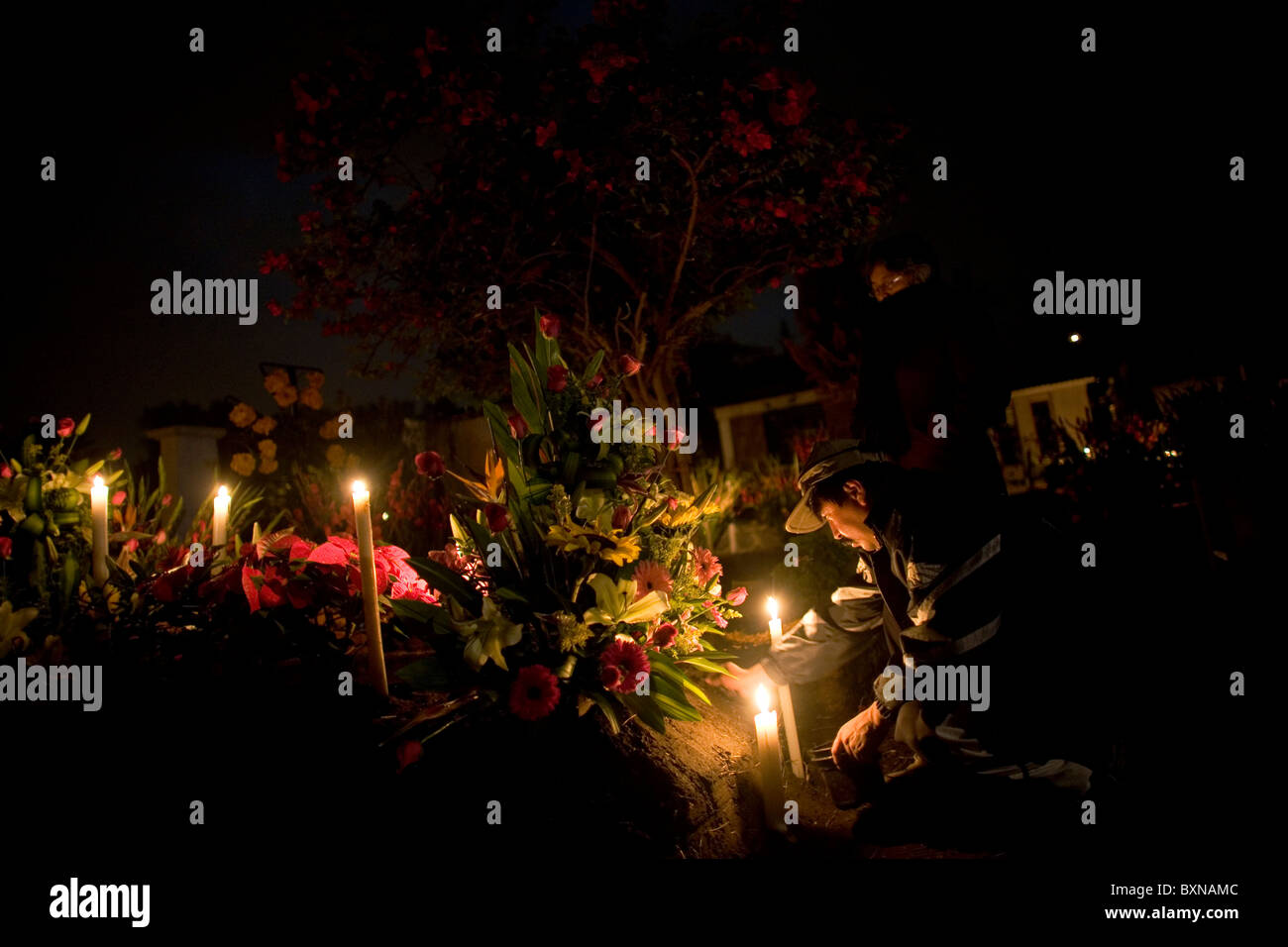 A man prepares the grave of a late family member at the cemetery in San Gregorio Atapulco, Xochimilco, Mexico City. Stock Photo