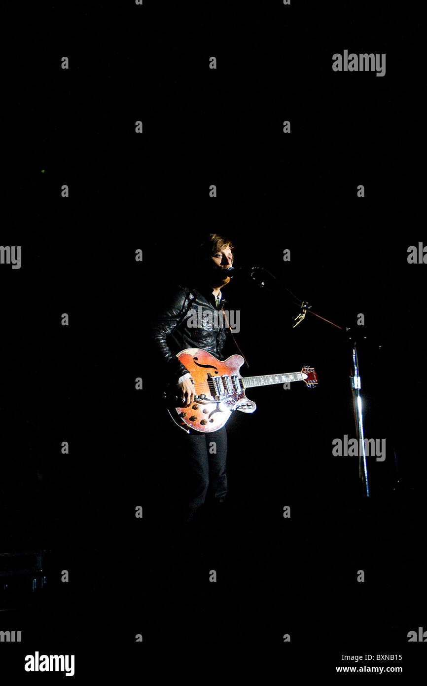 Dan Auerbach of rock band the Black Keys singing a song and playing