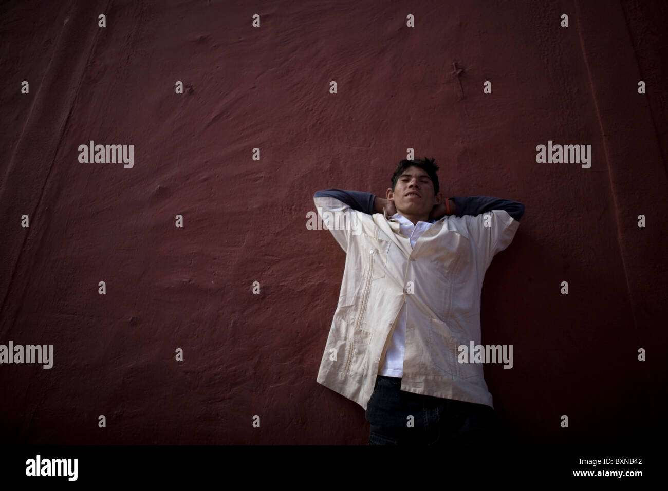 A Central American migrant traveling across Mexico to work in the United States sleeps in a shelter in Mexico City, Mexico Stock Photo