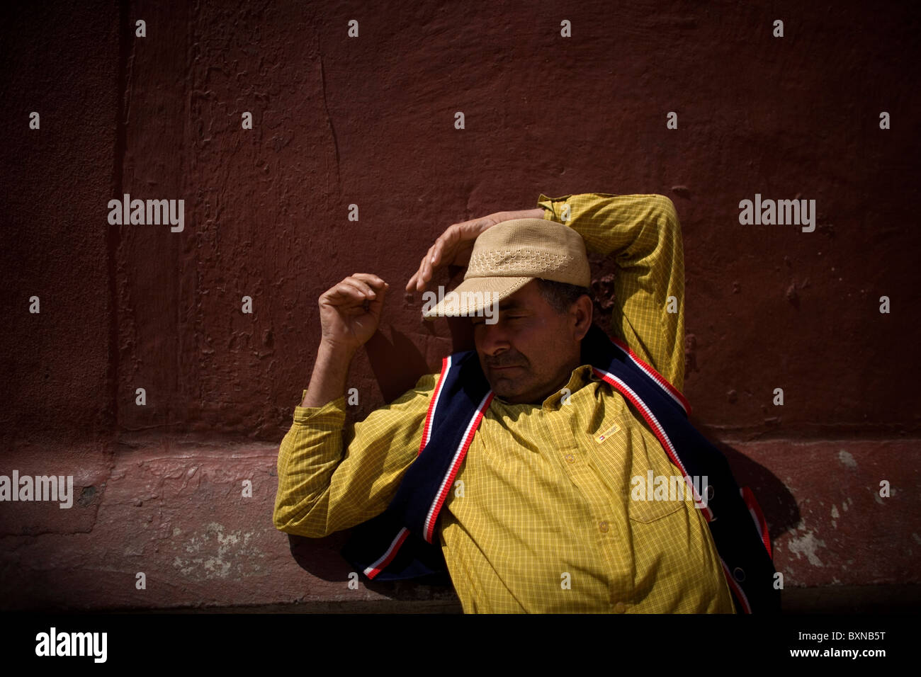 A Central American migrant traveling across Mexico to work in the United States sleeps in a shelter in Mexico City, Mexico Stock Photo