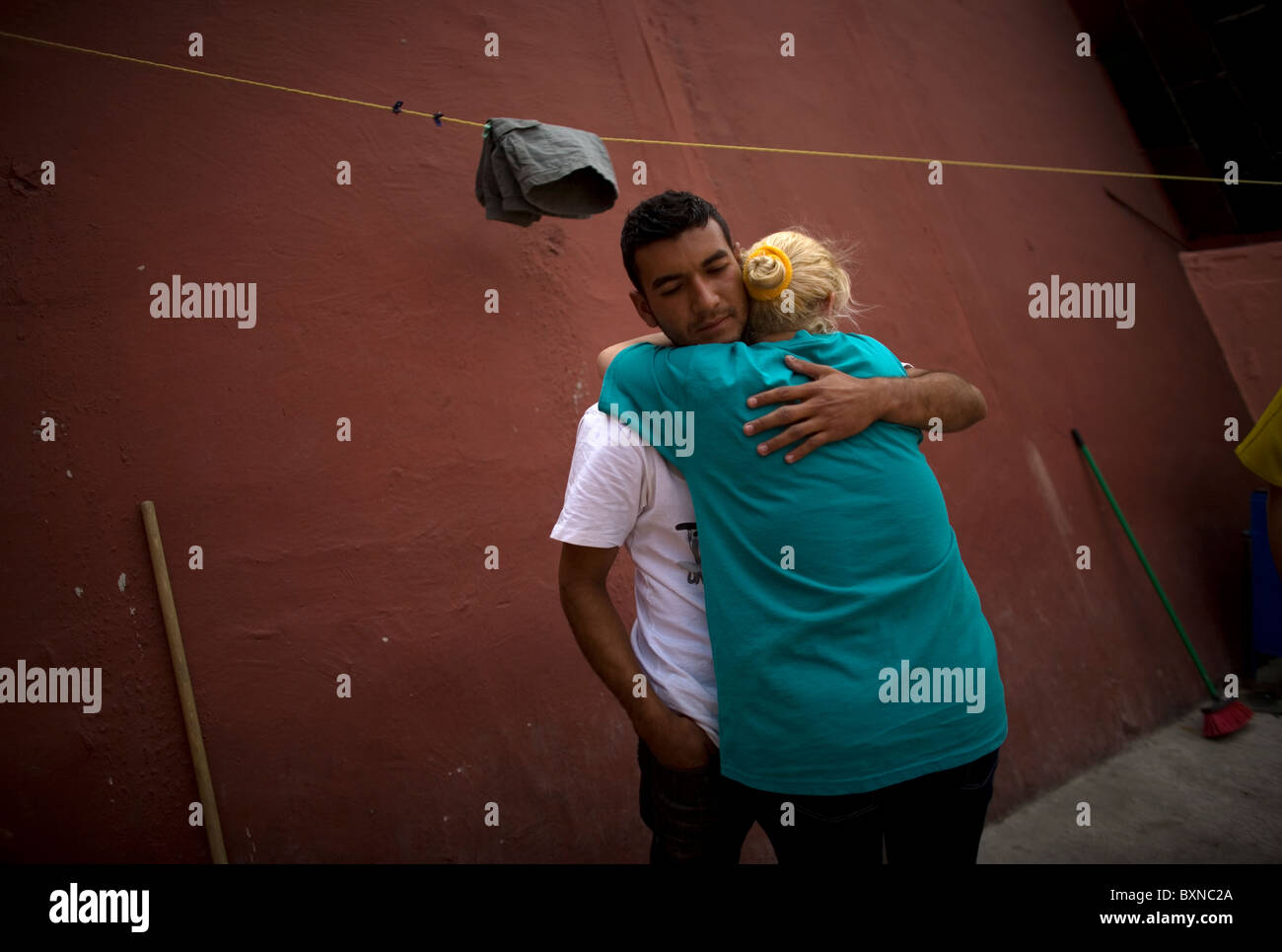 A woman hugs her son, a Central American migrant traveling across Mexico to work in the United States in Mexico City Stock Photo