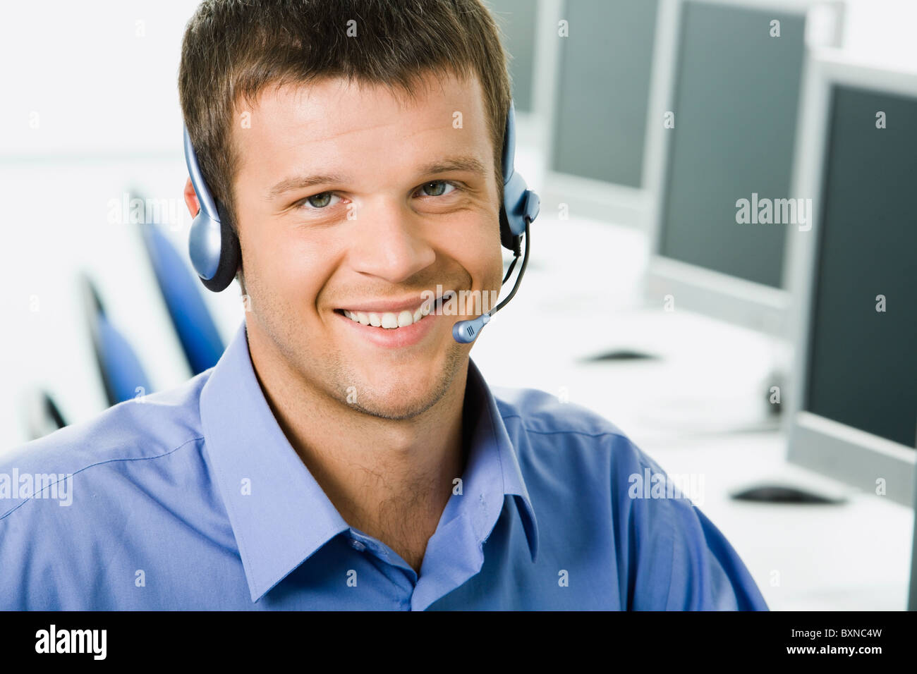 Friendly telephone operator smiling during a telephone conversation