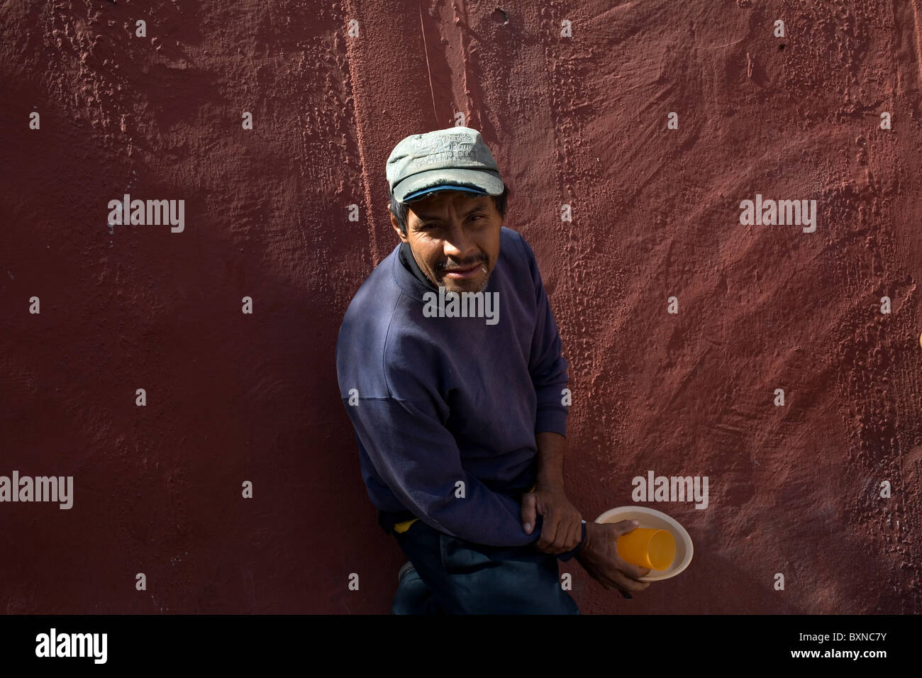 A Central American migrant traveling across Mexico to work in the United States stands in a shelter in Mexico City Stock Photo