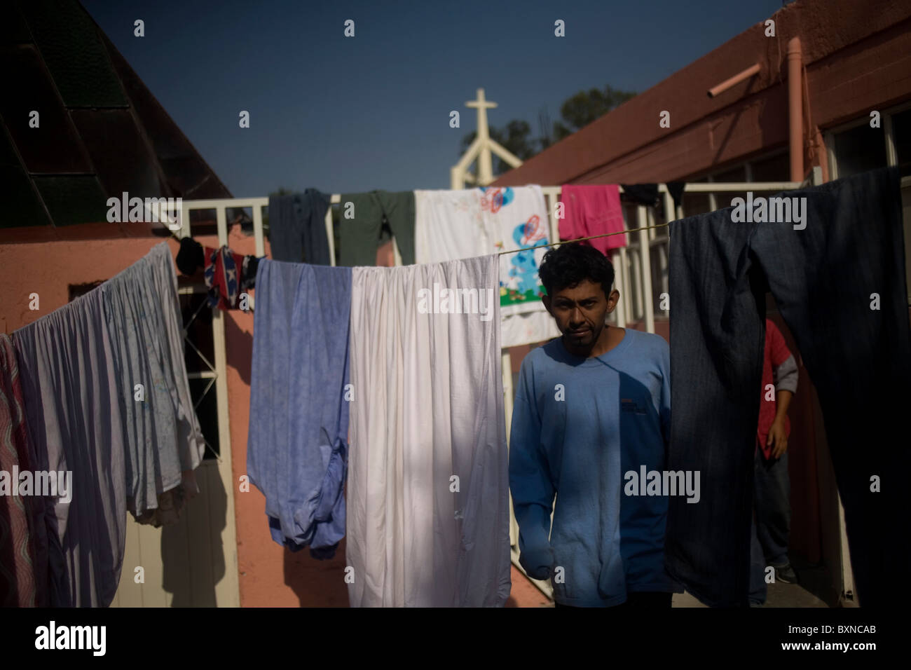 Central American migrant traveling across Mexico to work in the United States stands in a shelter in Mexico City Stock Photo