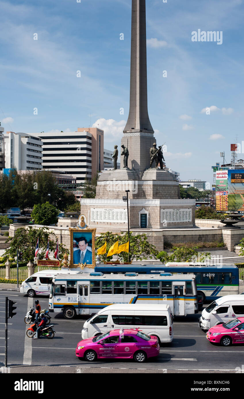 Photographs and other images of the King are everywhere in Thailand, as here in front of Victoria Monument in Bangkok. Stock Photo