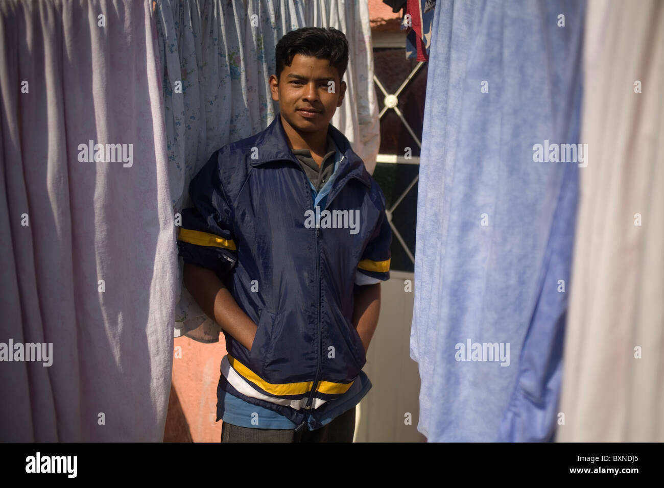 A Central American migrant traveling across Mexico to work in the United States pose for a picture in a shelter in Mexico City Stock Photo