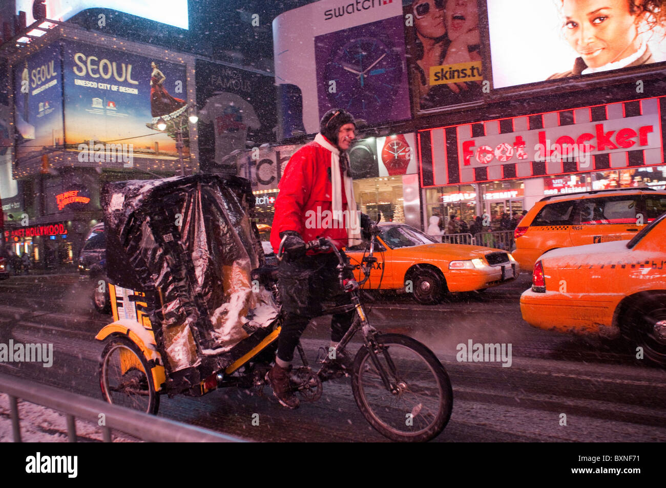 A pedicab driver maneuvers through the snow in Times Square in New York