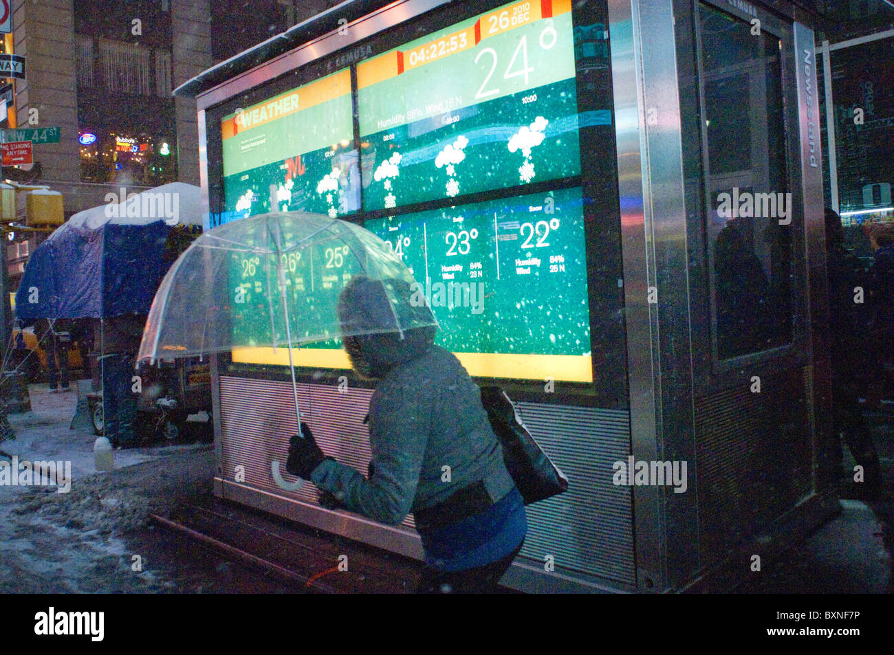 New Yorkers and visitors maneuver through the snow in Times Square in