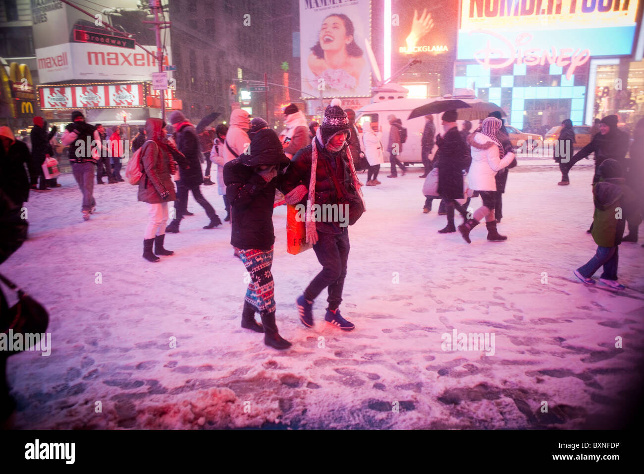 New Yorkers and visitors maneuver through the snow in Times Square in
