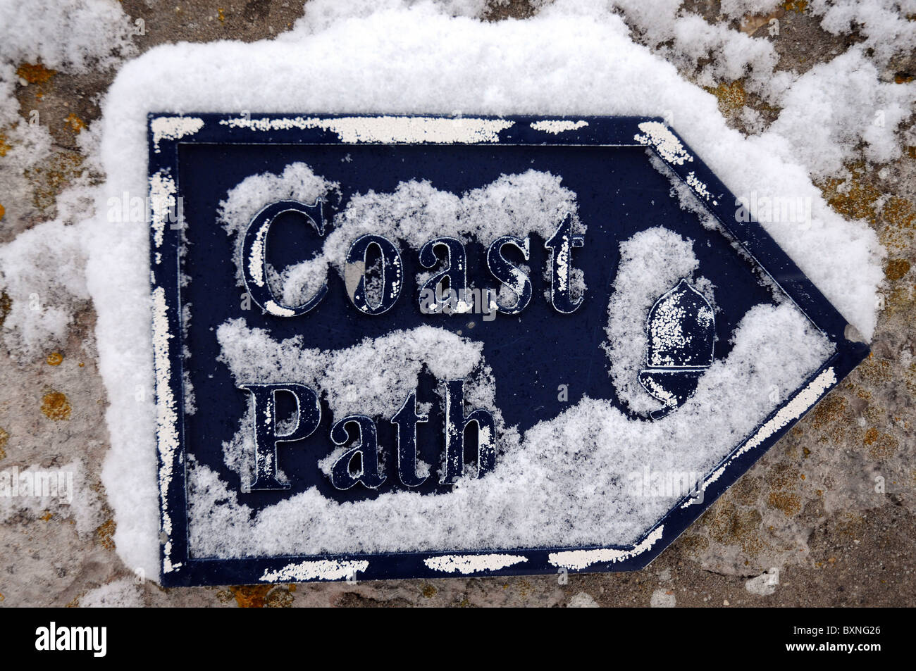 Snow on a coast path sign, UK Stock Photo