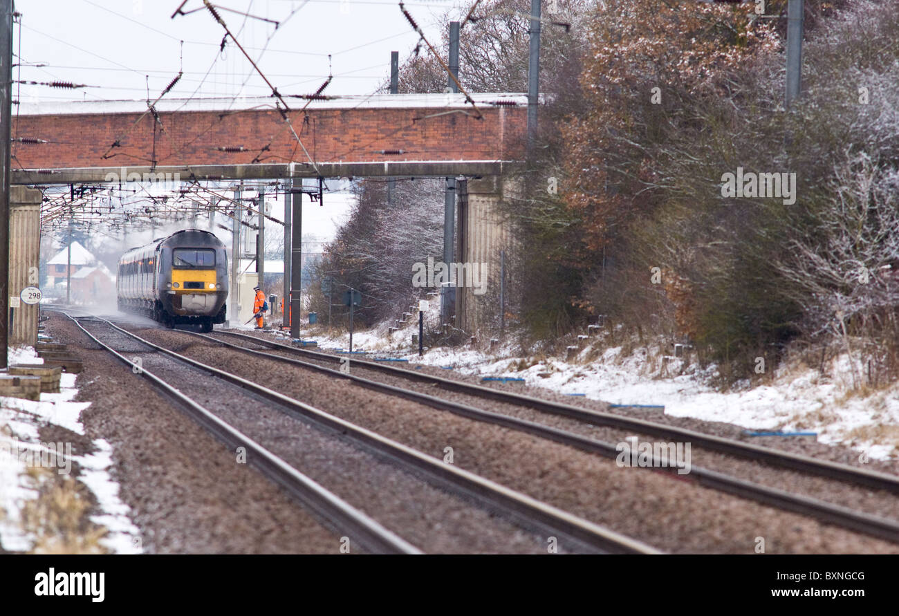Intercity 125 diesel train passes a rail worker on the east coast mainline. Stock Photo