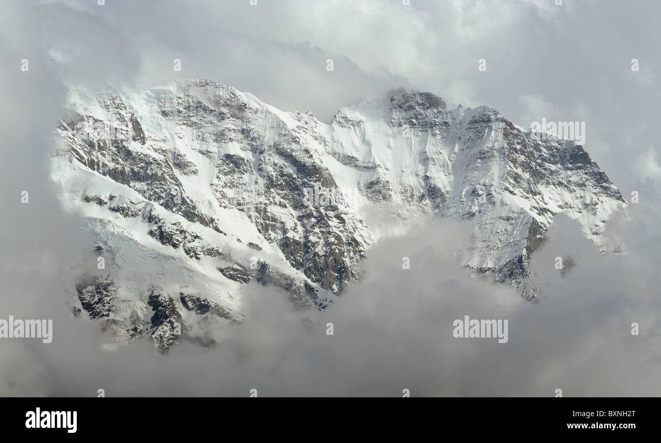 Peaks of Mountain range, surrounded by clouds Stock Photo