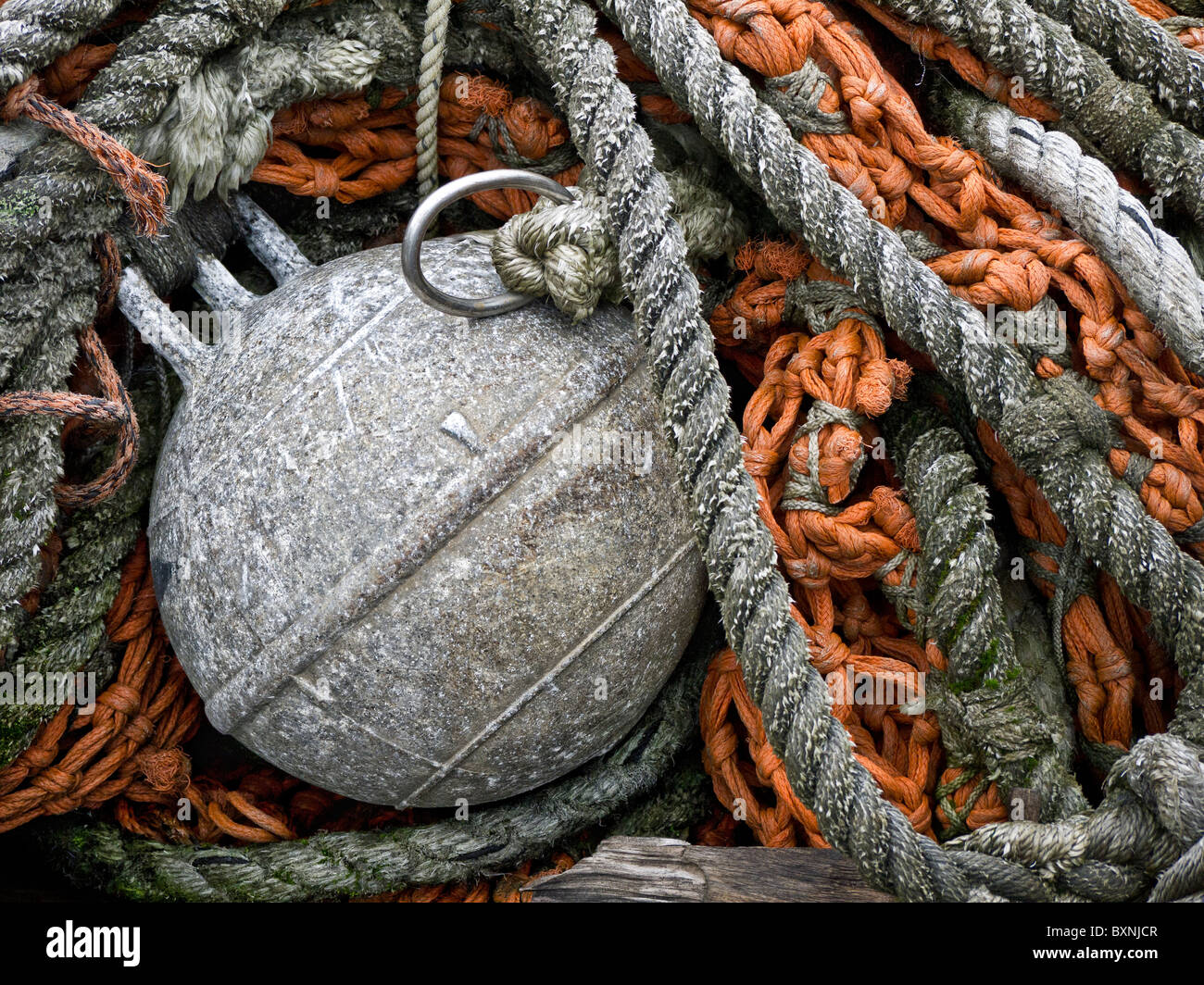 Piles of fishing nets and buoys. Stock Photo