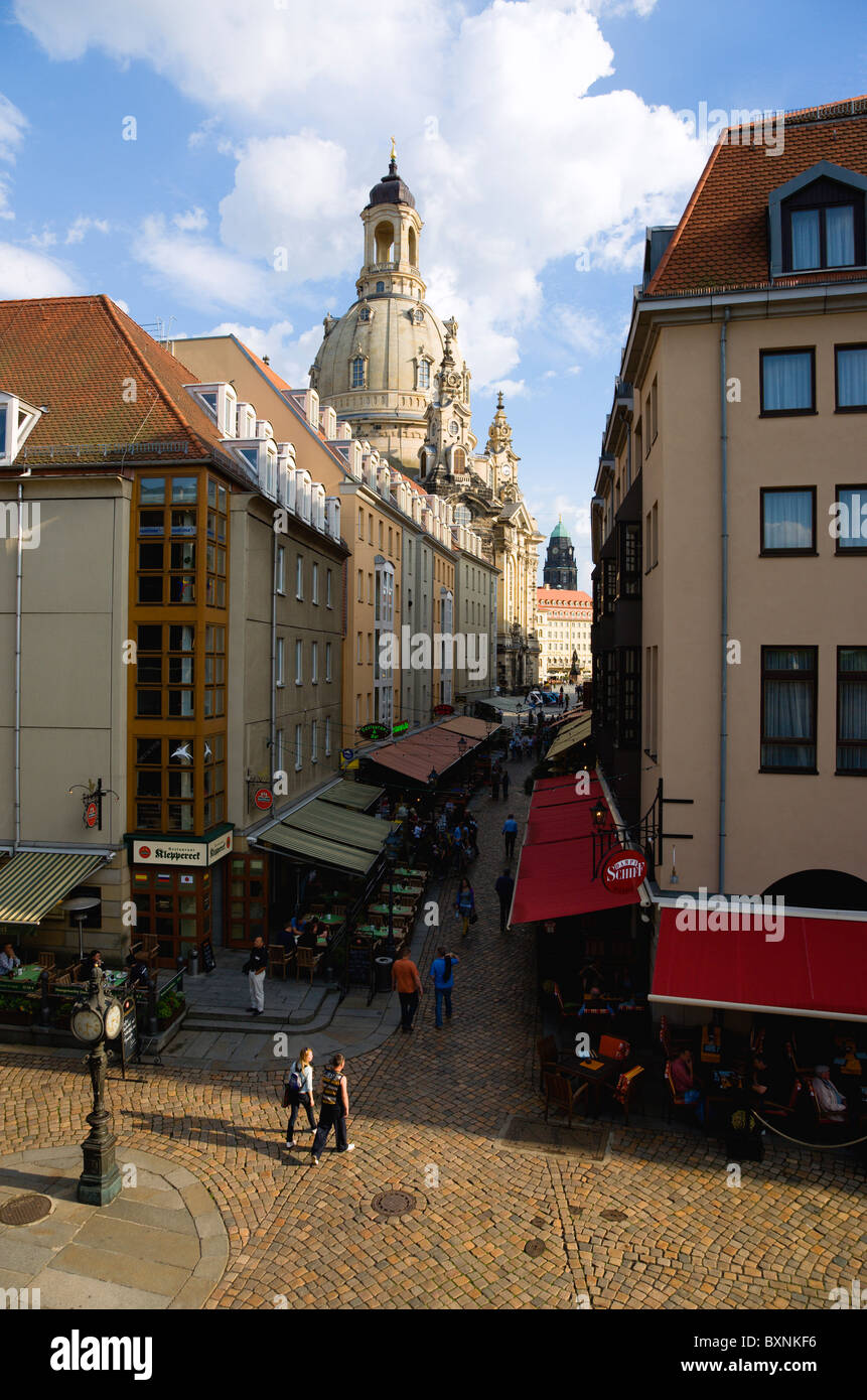GERMANY Saxony Dresden Restaurant and bar lined Munzgasse street with tourists leading to Neumarkt and Frauenkirche church Stock Photo