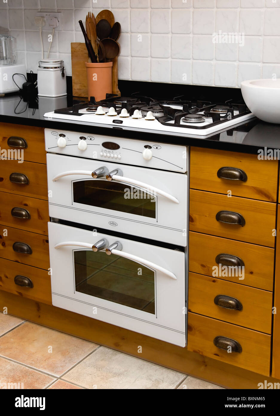 Architecture Interiors White domestic gas hob and electric oven household  appliance set under worktop in fitted kitchen Stock Photo - Alamy