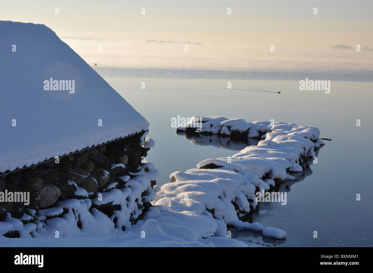 Snowy landscape by the sea, boat house, winter Stock Photo