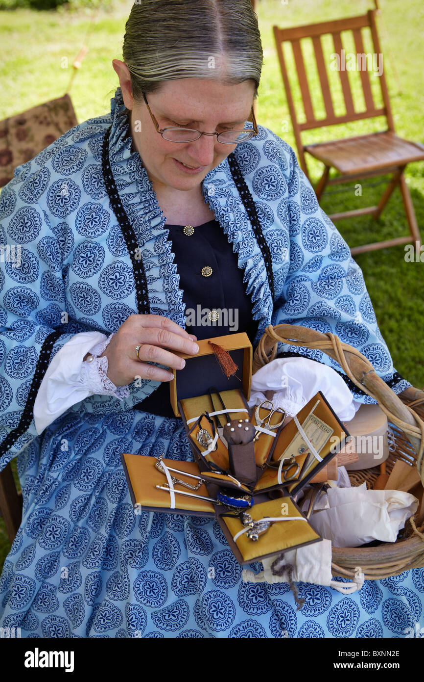 A reenactor portraying a seamstress in the Civil War encampment at historic Blenheim, Fairfax, Virginia. Stock Photo
