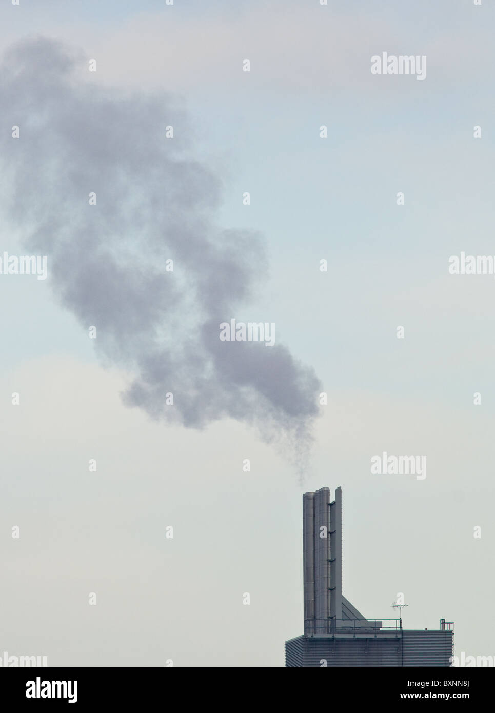 Steam and hot exhaust gases being emitted through steel chimneys Stock