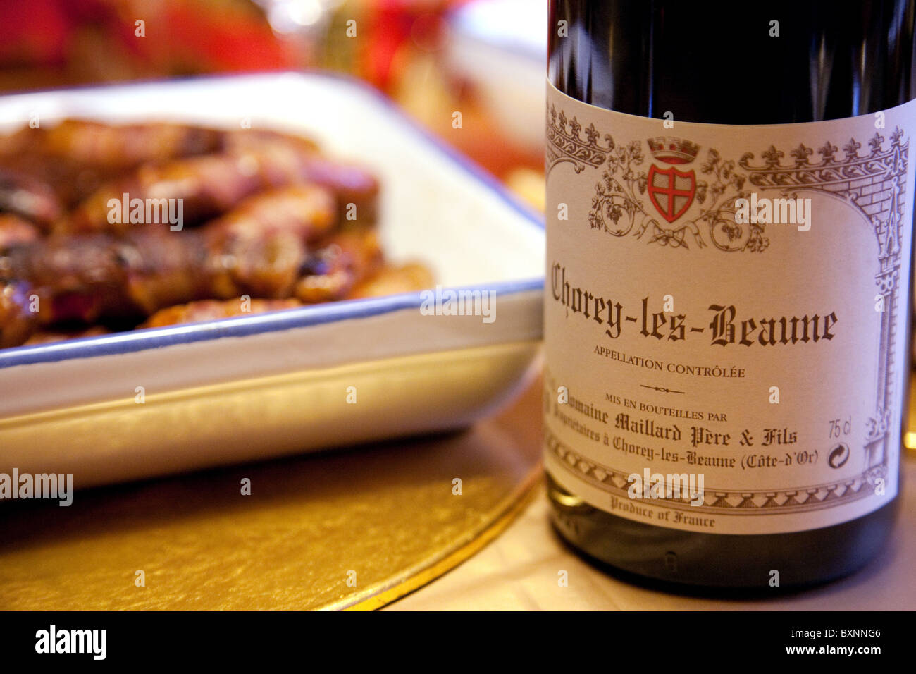 Christmas dinner table with a bottle of red burgundy wine Stock Photo