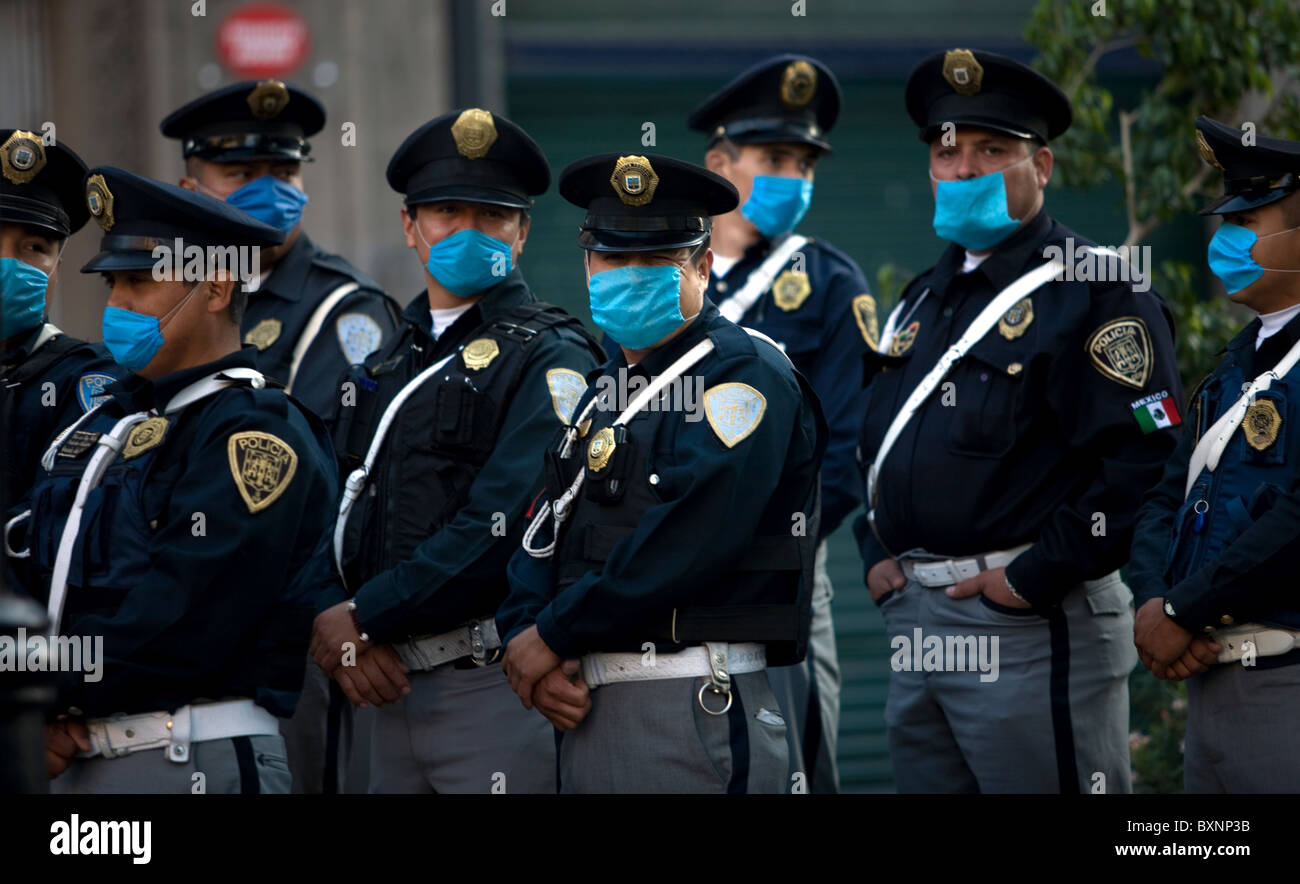 Policemen wearing masks as a precaution against swine flu walks in Mexico City's main Zocalo square, May 1, 2009. Stock Photo