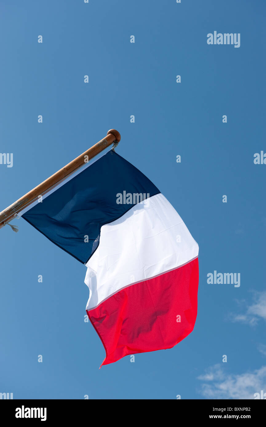French Flag Flying against Blue Sky Stock Photo