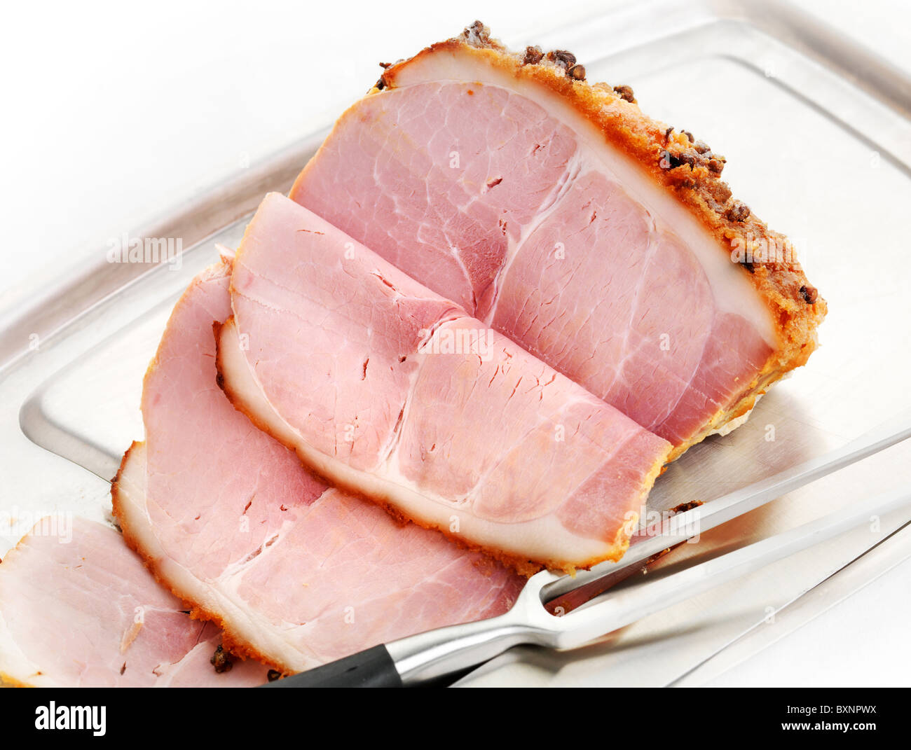 Freshley carved Honey Roast Ham with cloves and brown sugar coating Stock Photo
