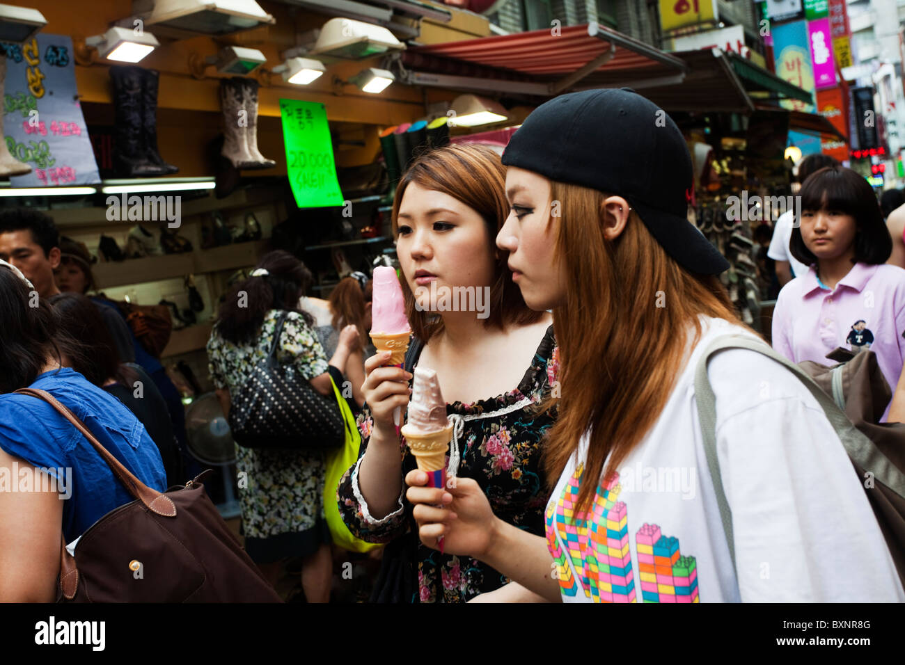 Girls with ice cream in a popular shopping area of Seoul, South Korea Stock Photo