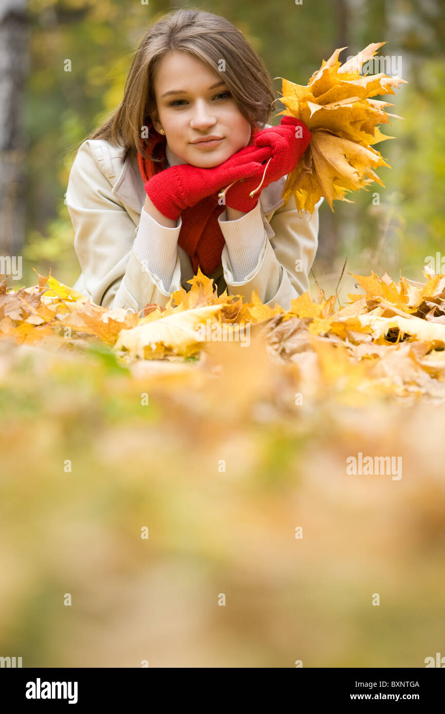 Image of resting young woman lying on foliage in autumn Stock Photo - Alamy