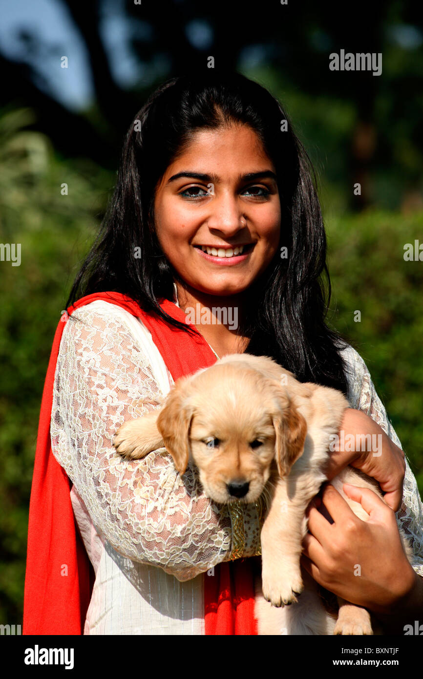 Smiling Indian girl with a puppy Stock Photo - Alamy